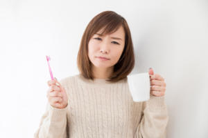 歯磨きについて考える女性